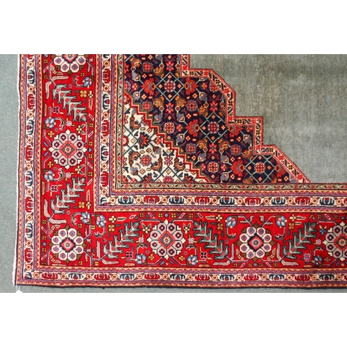 2134 - A GREEN GROUND TABRIZ RUGwith red geometric central medallion, dark blue and white spandrels and fol... 