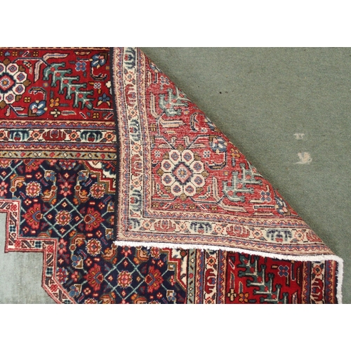 2134 - A GREEN GROUND TABRIZ RUGwith red geometric central medallion, dark blue and white spandrels and fol... 