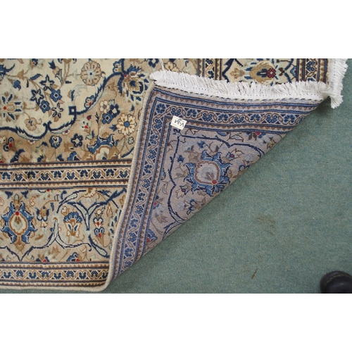 2135 - A CREAM GROUND KASHAN RUGwith diamond central medallion, matching spandrels and flower head borders,... 