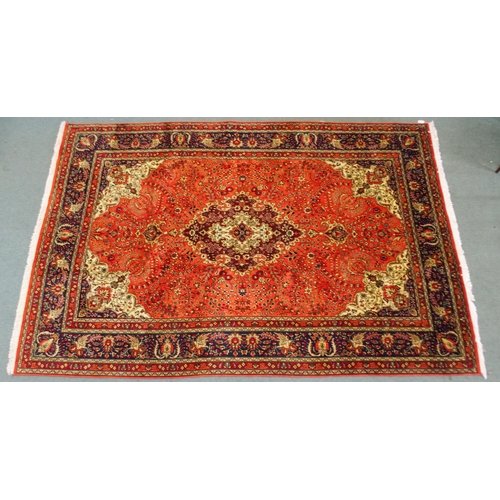 2137 - A TERRACOTTA GROUND TABRIZ RUGwith red and cream central medallion, cream and dark blue spandrels an... 