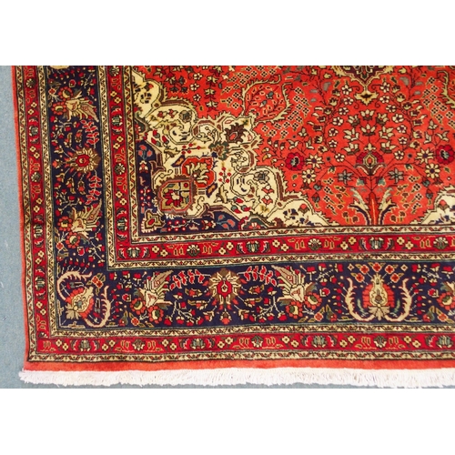 2137 - A TERRACOTTA GROUND TABRIZ RUGwith red and cream central medallion, cream and dark blue spandrels an... 