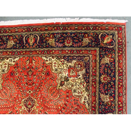 2137 - A TERRACOTTA GROUND TABRIZ RUGwith red and cream central medallion, cream and dark blue spandrels an... 