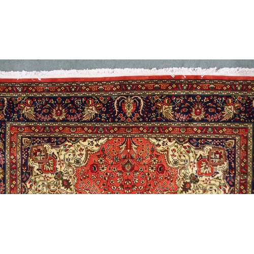 2137 - A TERRACOTTA GROUND TABRIZ RUGwith red and cream central medallion, cream and dark blue spandrels an... 