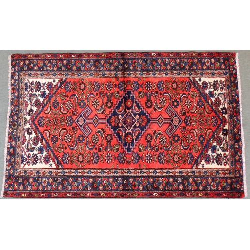 2138 - A TERRACOTTA GROUND HAMADAN RUGwith dark blue central medallion, cream spandrels and blue floral bor... 