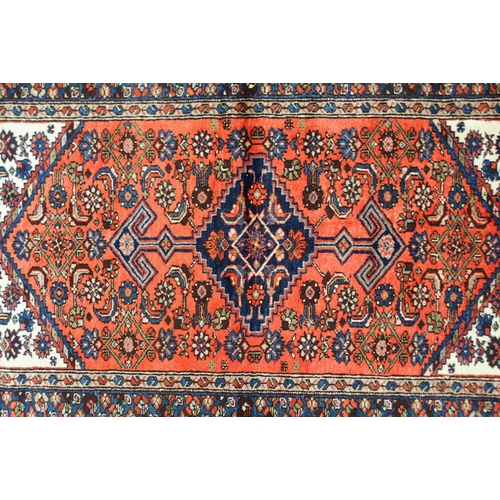 2138 - A TERRACOTTA GROUND HAMADAN RUGwith dark blue central medallion, cream spandrels and blue floral bor... 