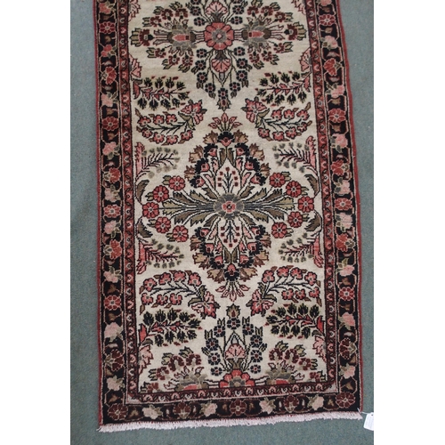 2139 - A CREAM GROUND HAMADAN RUNNERwith seven floral medallions and dark blue floral border, 459cm long x ... 