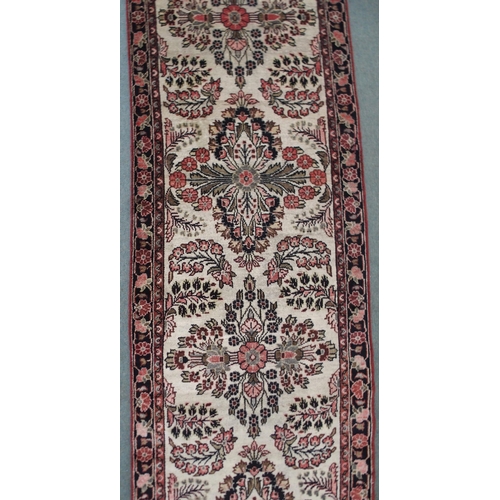 2139 - A CREAM GROUND HAMADAN RUNNERwith seven floral medallions and dark blue floral border, 459cm long x ... 