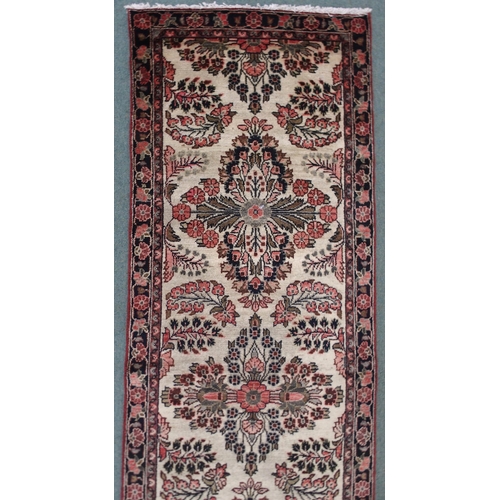 2139 - A CREAM GROUND HAMADAN RUNNERwith seven floral medallions and dark blue floral border, 459cm long x ... 