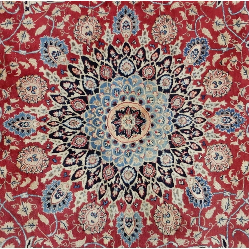 2141 - A RED GROUND KESHAN RUGwith blue central medallion, matching spandrels and dark blue border, 373cm l... 