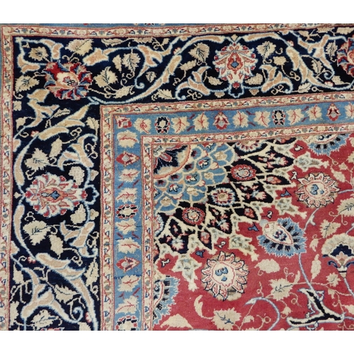 2141 - A RED GROUND KESHAN RUGwith blue central medallion, matching spandrels and dark blue border, 373cm l... 