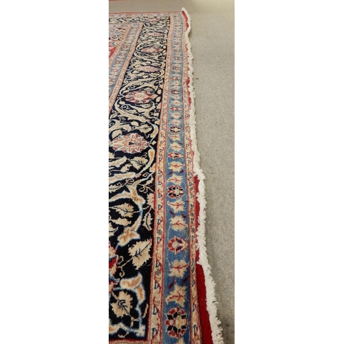 2141 - A RED GROUND KESHAN RUGwith blue central medallion, matching spandrels and dark blue border, 373cm l... 