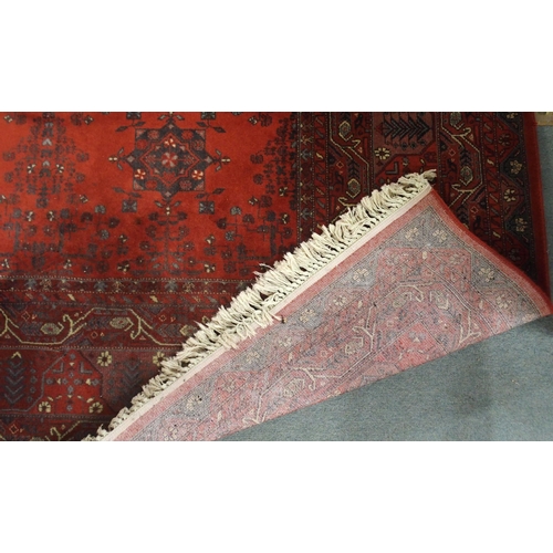 2144 - A DARK RED GROUND AXMINSTER STYLE RUGwith all-over design, multicoloured geometric borders, 366cm lo... 