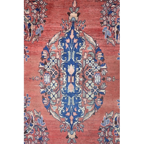 2146 - A LIGHT RED GROUND MAHAL RUGwith floral multicoloured central medallion, matching spandrels and flow... 