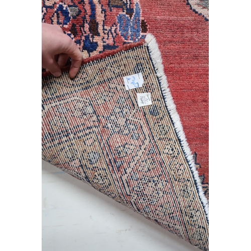 2146 - A LIGHT RED GROUND MAHAL RUGwith floral multicoloured central medallion, matching spandrels and flow... 