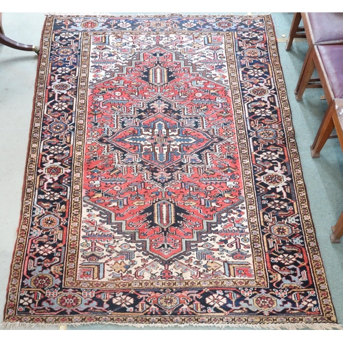 2147 - A RED GROUND KAZAK RUGwith dark blue geometric central medallion, off white spandrels and geometric ... 