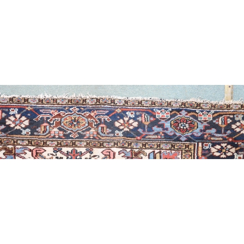 2147 - A RED GROUND KAZAK RUGwith dark blue geometric central medallion, off white spandrels and geometric ... 