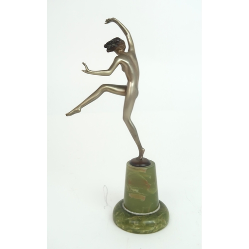 2153 - IN THE STYLE OF JOSEF LORENZL a silvered Art Deco figure of a girl balancing on one foot w... 