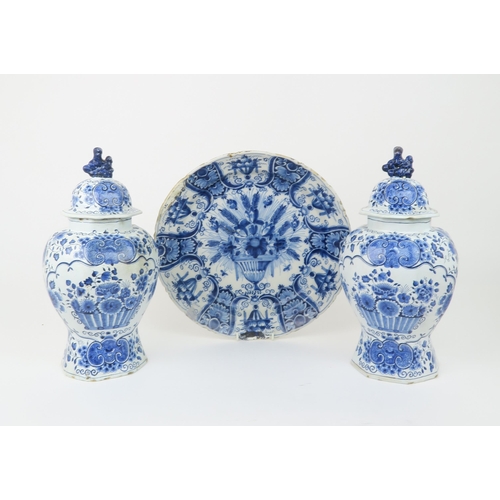 2172A - A LARGE DELFT DISHdecorated with a basket of flowers, 34.5cm diameter, together with a pair of Delft... 