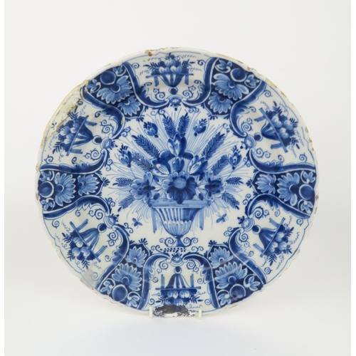 2172A - A LARGE DELFT DISHdecorated with a basket of flowers, 34.5cm diameter, together with a pair of Delft... 