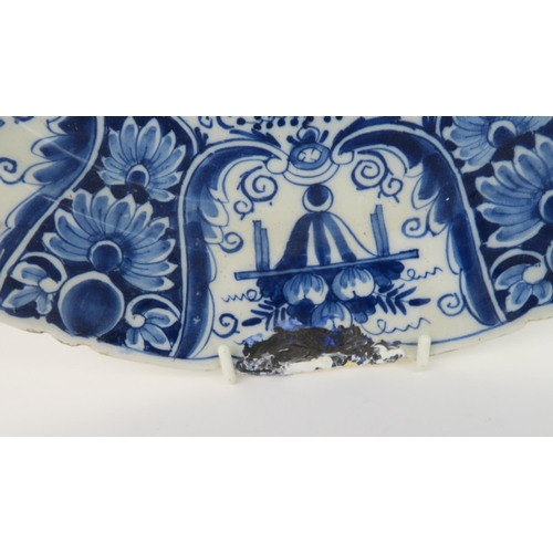 2172A - A LARGE DELFT DISHdecorated with a basket of flowers, 34.5cm diameter, together with a pair of Delft... 