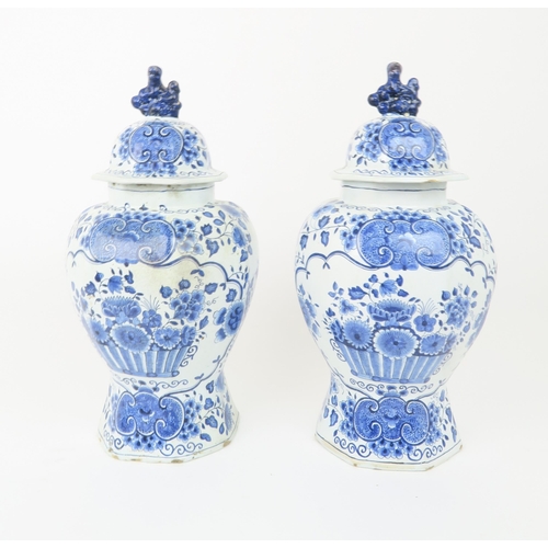 2172A - A LARGE DELFT DISHdecorated with a basket of flowers, 34.5cm diameter, together with a pair of Delft... 