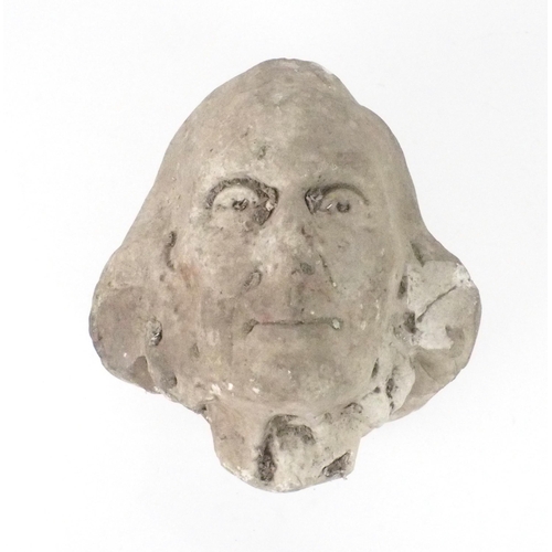 2184 - A CARVED COMPOSITE STONE HEAD OF A MAN28cm high