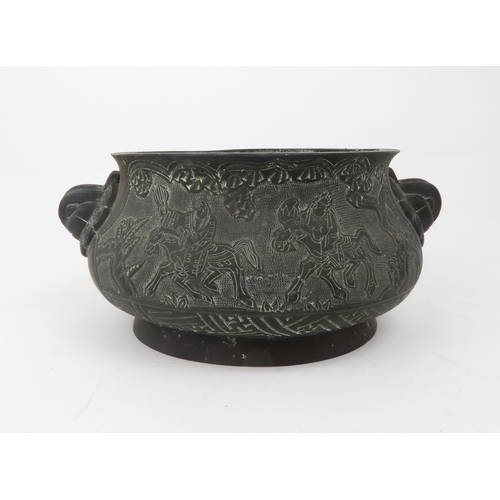 2356 - A CHINESE BRASS CENSER Decorated with panels of figures beneath trees, mask handles and six characte... 