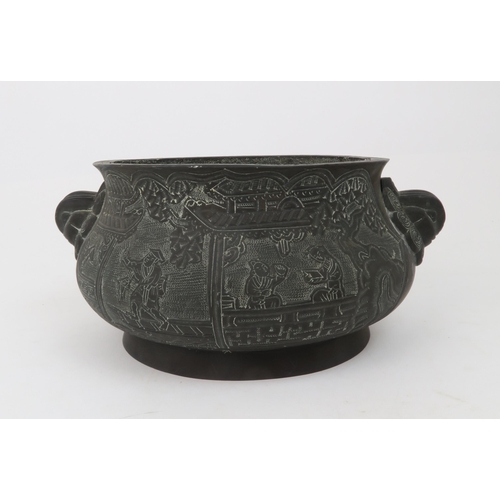 2356 - A CHINESE BRASS CENSER Decorated with panels of figures beneath trees, mask handles and six characte... 