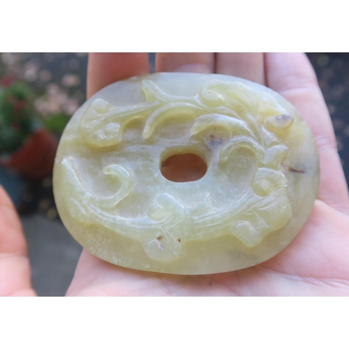 2361 - A CHINESE JADE BUTTON HOOKCarved with a chilong, 9.5cm long and three modern hardstone carved discs,... 