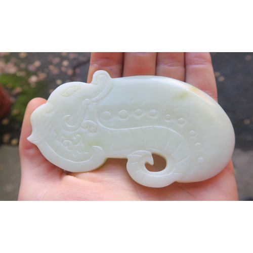 2361 - A CHINESE JADE BUTTON HOOKCarved with a chilong, 9.5cm long and three modern hardstone carved discs,... 