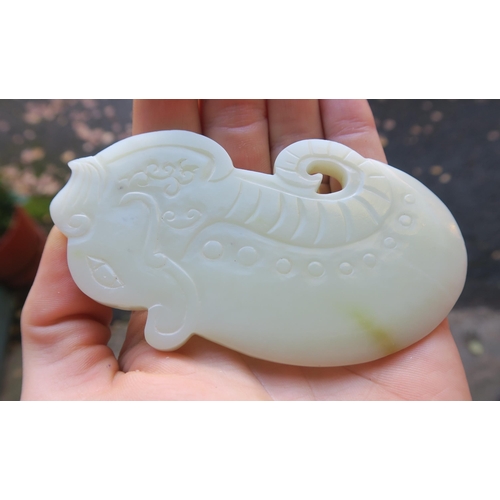 2361 - A CHINESE JADE BUTTON HOOKCarved with a chilong, 9.5cm long and three modern hardstone carved discs,... 