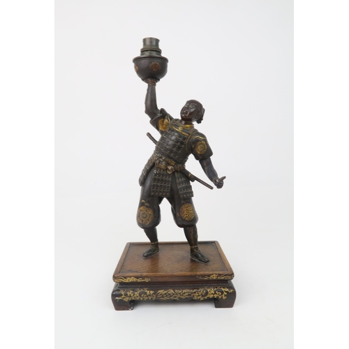 2366 - A JAPANESE BRONZE SAMURAI LAMP Standing and wearing battle dress, decorated with family Mon crests a... 