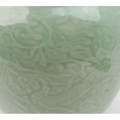 2371 - A CHINESE CELADON VASE Carved with an archaic band above scrolling foliage, and horizontal banding, ... 