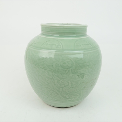 2371 - A CHINESE CELADON VASE Carved with an archaic band above scrolling foliage, and horizontal banding, ... 