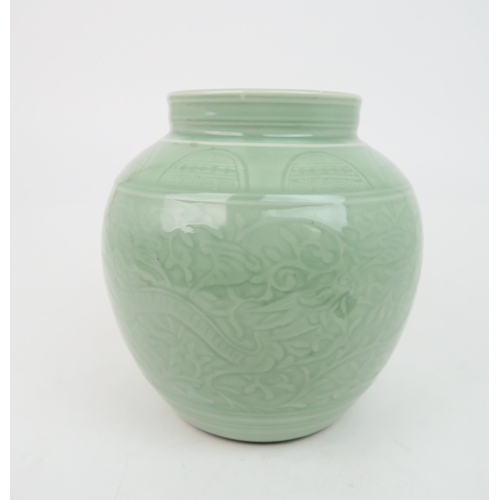 2371 - A CHINESE CELADON VASE Carved with an archaic band above scrolling foliage, and horizontal banding, ... 