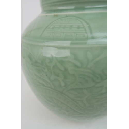 2371 - A CHINESE CELADON VASE Carved with an archaic band above scrolling foliage, and horizontal banding, ... 