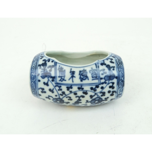 2374 - A CHINESE BLUE AND WHITE BARREL BIRD FEEDER Painted with meandering foliage, joined with two pierced... 