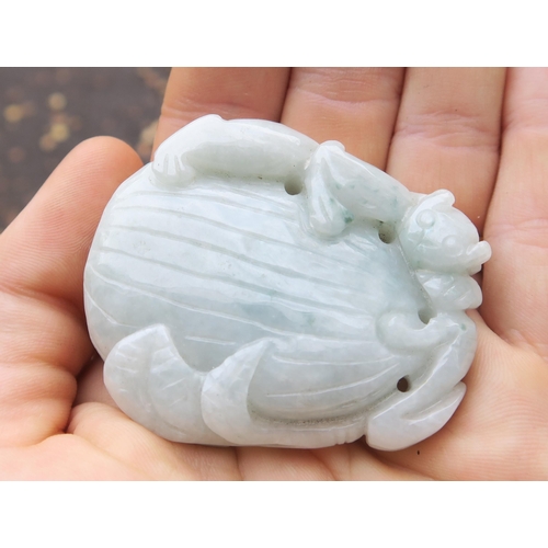 2378 - A CHINESE JADEITE PENDANT Carved with a feline on a fruit, 5cm high, Bi disc, 6.5cm wide and a ... 