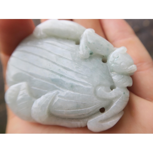 2378 - A CHINESE JADEITE PENDANT Carved with a feline on a fruit, 5cm high, Bi disc, 6.5cm wide and a ... 