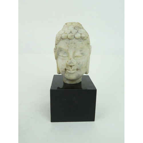 2379 - AN INDIAN MARBLE BUST OF BUDDHA Mounted on a marble base, 20th century, 22.5cm high overall and... 