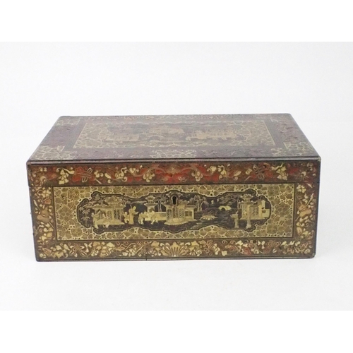 2382 - A CANTON BLACK AND GOLD LAQUERED WRITING SLOPE Decorated with various panels, fitted with velvet ski... 