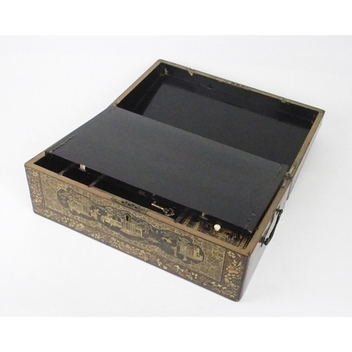 2382 - A CANTON BLACK AND GOLD LAQUERED WRITING SLOPE Decorated with various panels, fitted with velvet ski... 