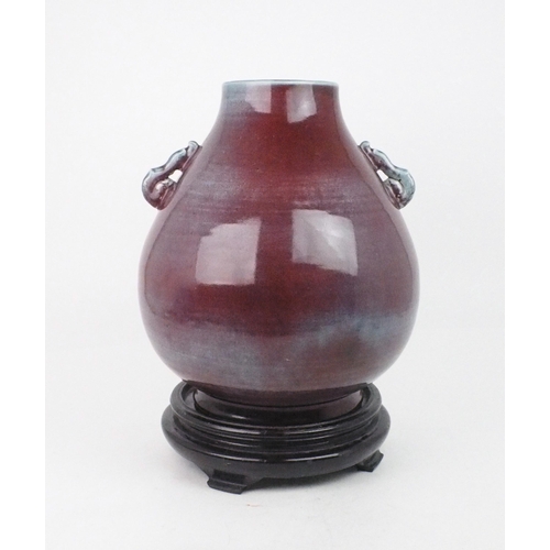 A CHINESE FLAMBE BROAD OVIFORM VASE Applied with serpent handles 