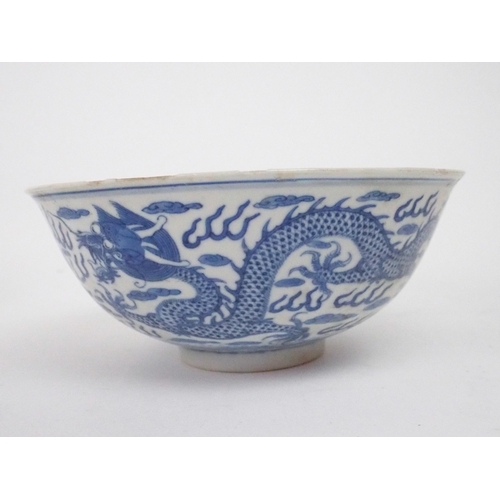 2392 - A CHINESE CELADON GLAZED BOWL Carved with foliage, 19.5cm diameter and a blue and white dragon bowl,... 