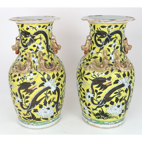 2399 - A PAIR OF CHINESE YELLOW GROUND VASES Each applied with gilt dragons and shishi, amongst scroll... 