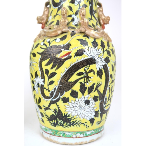 2399 - A PAIR OF CHINESE YELLOW GROUND VASES Each applied with gilt dragons and shishi, amongst scroll... 