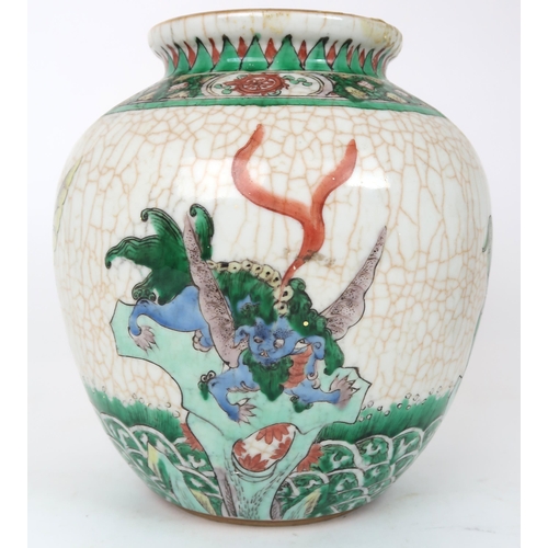 2400 -  A CHINESE FAMILLE VERTE JAR Painted with winged shishi on a crackled ground and bene... 