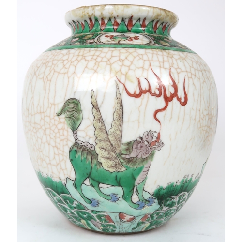 2400 -  A CHINESE FAMILLE VERTE JAR Painted with winged shishi on a crackled ground and bene... 