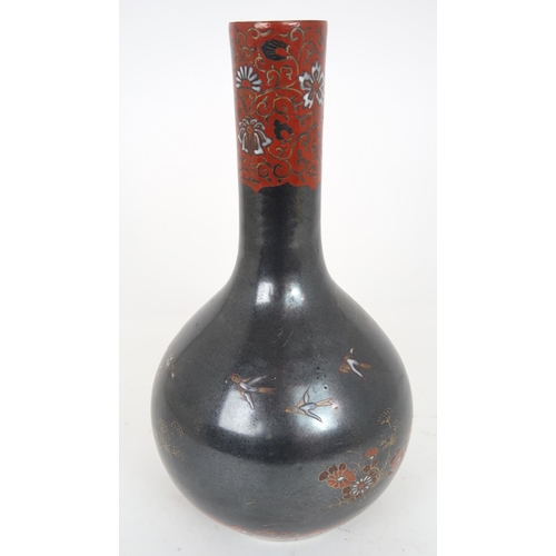 2407 - A CHINESE BALUSTER VASE Painted with polychrome colours on a dark ground with birds amongst fol... 