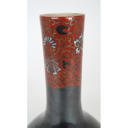 2407 - A CHINESE BALUSTER VASE Painted with polychrome colours on a dark ground with birds amongst fol... 